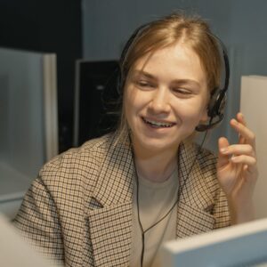 A Woman in Brown and White Plaid Blazer Wearing Black Headphones